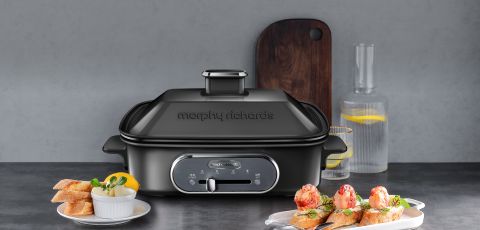 The Multifunction Cooking Pot in black with prawn canapes
